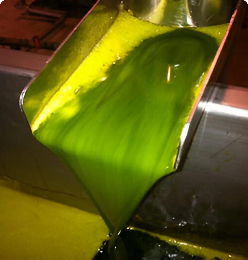 136373137 (1) Green liquid pouring from metal chute.