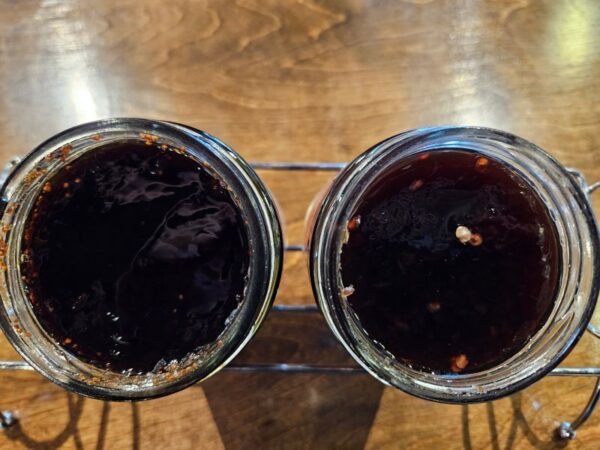 Two jars of coffee sitting on top of a table.