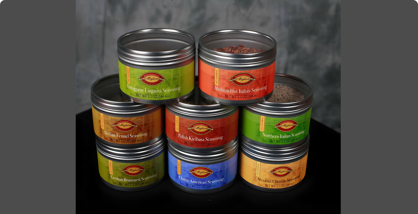 Group 23 Stacked metal spice tins with colorful labels.