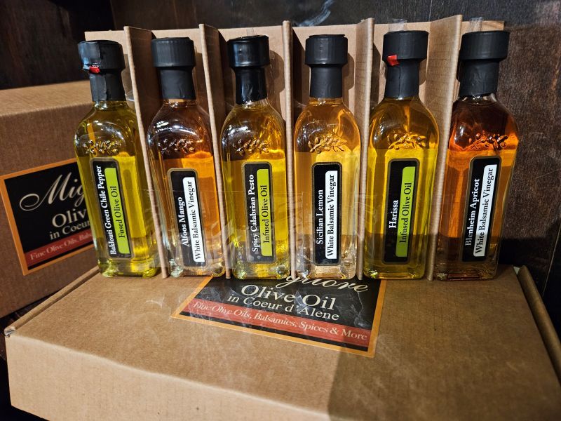 A group of bottles of oil sitting on top of a table.