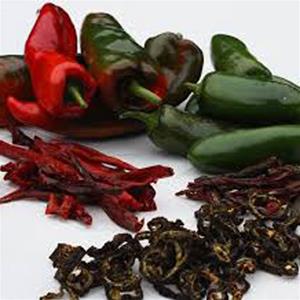 Fresh and dried peppers on white background.