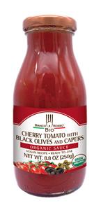 Organic cherry tomato sauce in glass bottle.