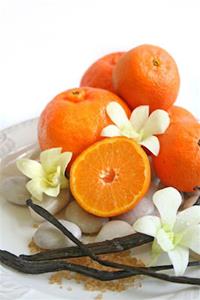 Oranges with flowers and vanilla beans arrangement.