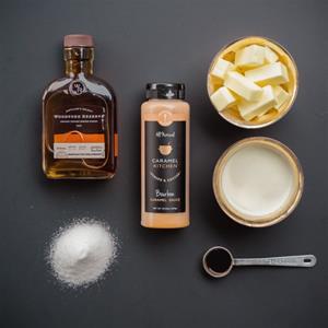 Ingredients for caramel sauce on black background.