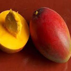 Ripe mango, whole and sliced open.