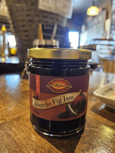 Jar of jalapeño fig jam on table.