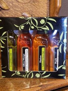 Four bottles of flavored oils and vinegar.