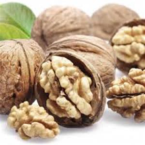 Walnuts with shells and leaves displayed.