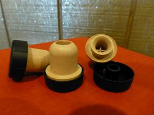 Wooden bottle stoppers on red surface.