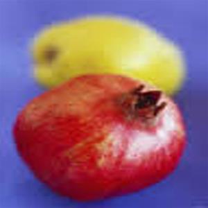 Pomegranate and pear on a blue surface.