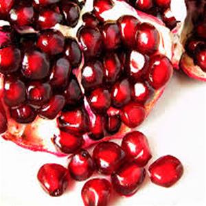 Pomegranate seeds and fruit close-up.