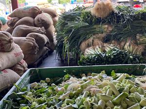 Vegetables and sacks in a market setting.