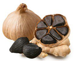 Black garlic bulbs and cloves on display.
