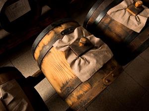 Wooden barrels with cloth covers in cellar.