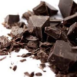 Chunks of dark chocolate on white background.