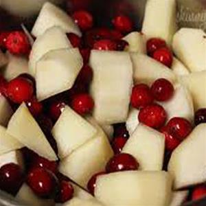 Chopped apples and cranberries in a bowl.
