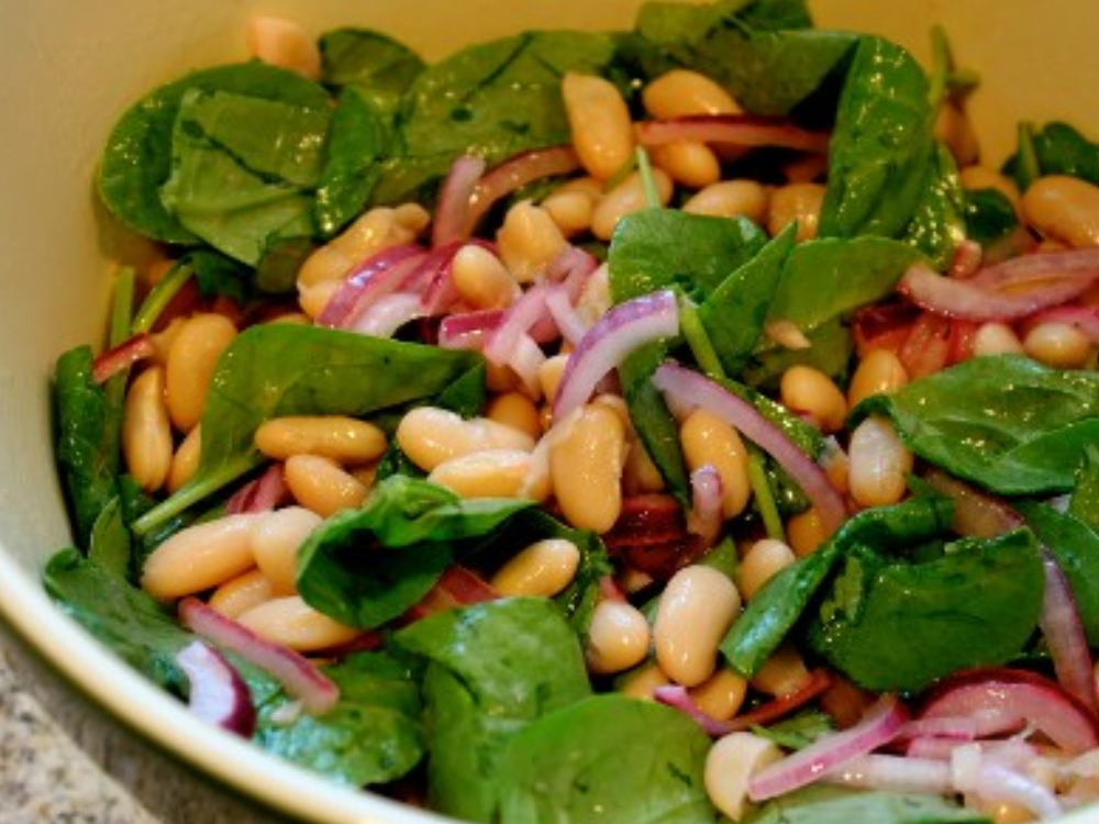133295164 (3) A bowl of salad with spinach, beans and onions.