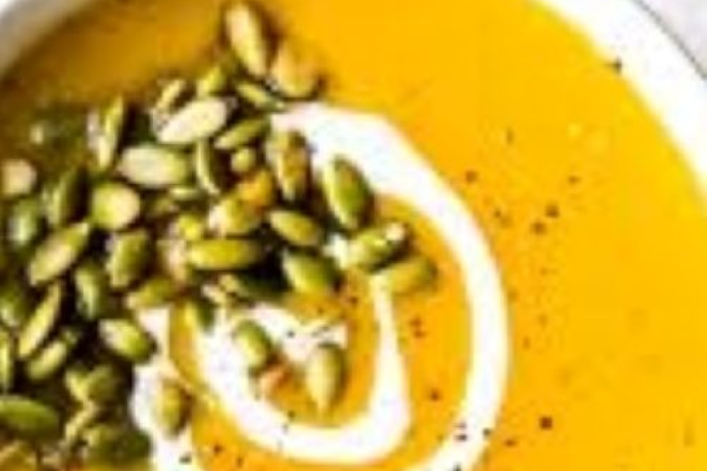 GettyImages-1441676660 (1) A bowl of pumpkin seeds and yogurt on the side.